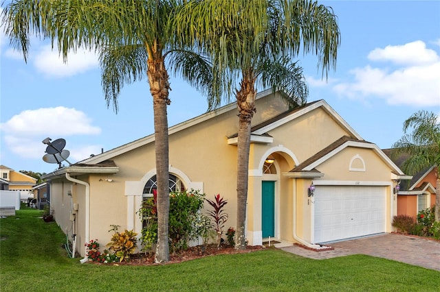 ranch-style home featuring a garage and a front lawn