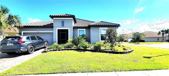 mediterranean / spanish-style house featuring a garage and a front yard