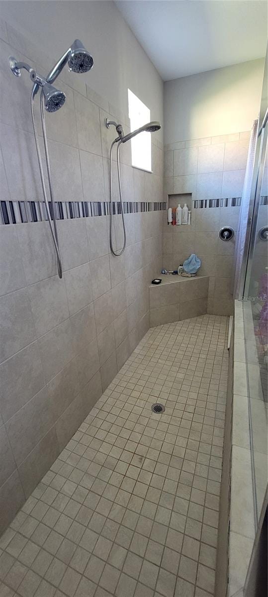 bathroom with tiled shower