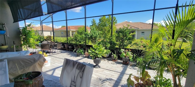 view of patio featuring a lanai