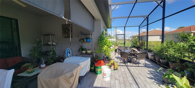 view of patio featuring glass enclosure