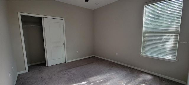 unfurnished bedroom with carpet flooring and a closet