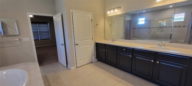 bathroom featuring tile patterned floors, vanity, and shower with separate bathtub