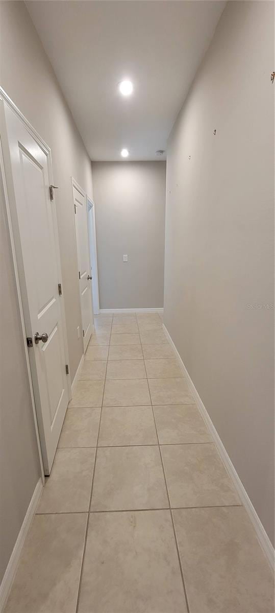 hallway with light tile patterned floors