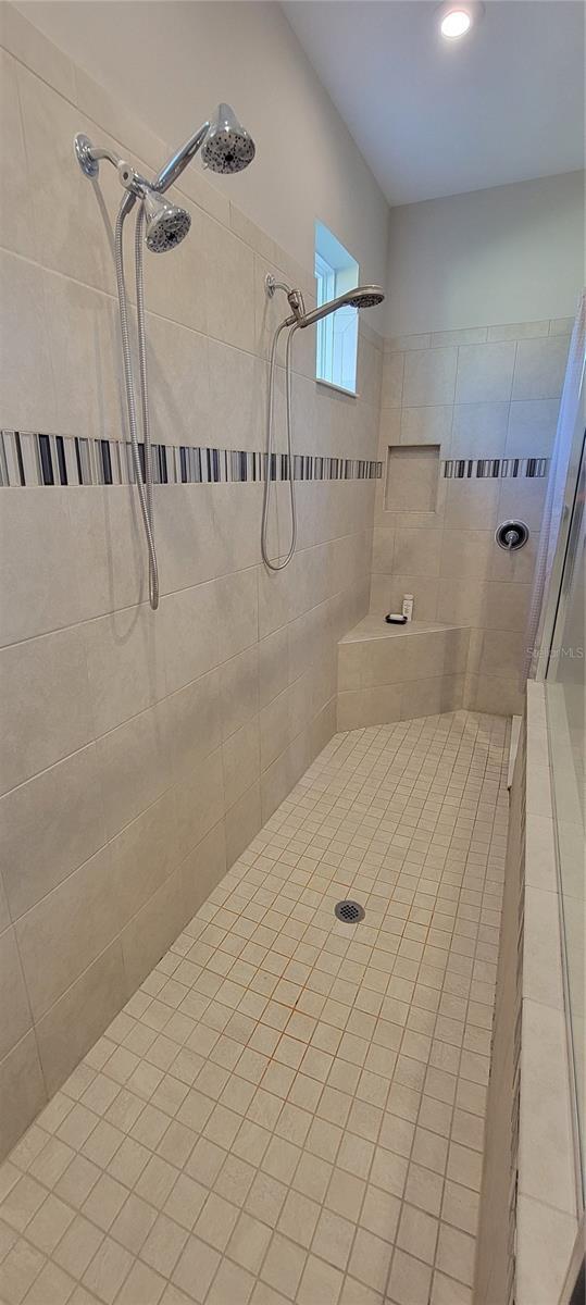 bathroom with tiled shower