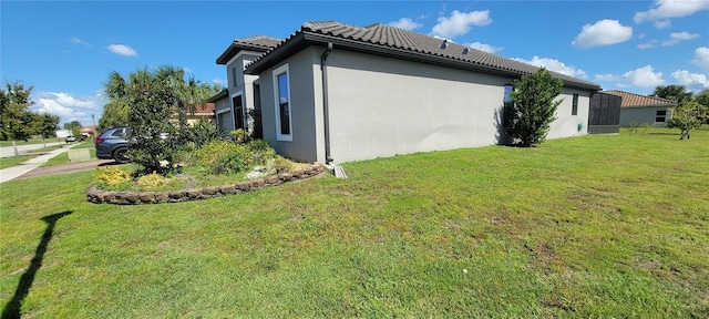 view of side of property with a yard