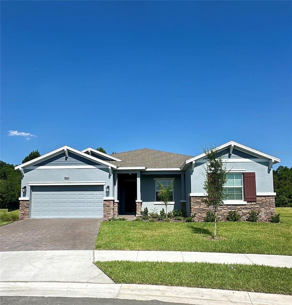 view of front facade with a front yard and a garage