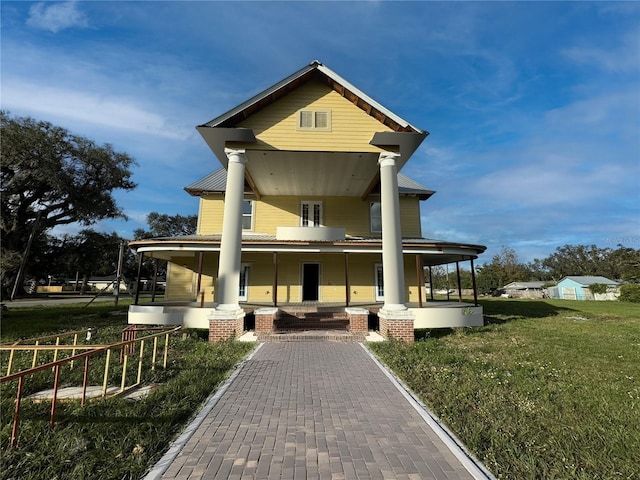 view of front facade with a front yard and a porch