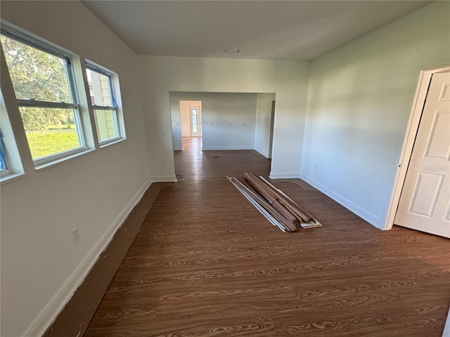 empty room with dark hardwood / wood-style floors