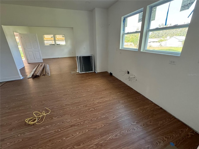 unfurnished living room featuring dark wood-type flooring