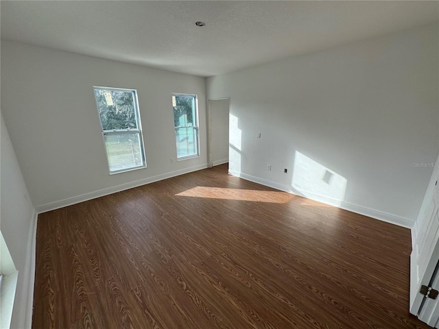 unfurnished room featuring dark hardwood / wood-style floors