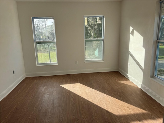 unfurnished room featuring dark wood-type flooring