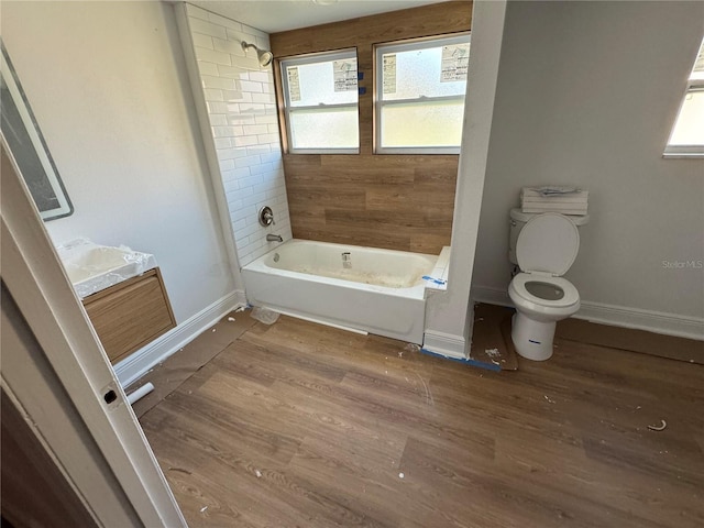 full bathroom with wood-type flooring, toilet, shower / bath combination, and vanity