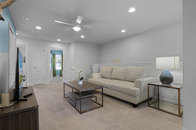 carpeted living room featuring ceiling fan