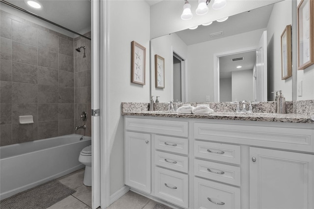 full bathroom featuring toilet, vanity, tile patterned floors, and tiled shower / bath