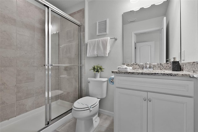 bathroom with tile patterned flooring, vanity, an enclosed shower, and toilet