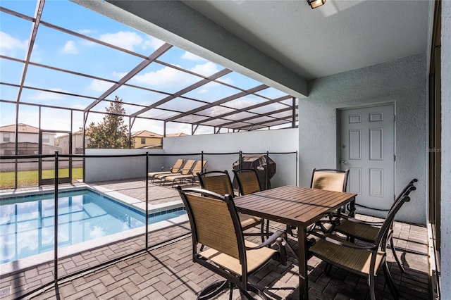 view of swimming pool featuring a patio area and a lanai