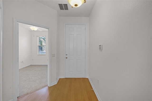 corridor with light wood-type flooring