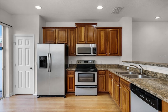 kitchen featuring sink, light hardwood / wood-style flooring, and appliances with stainless steel finishes