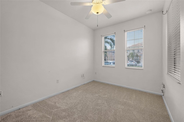 empty room with ceiling fan and carpet flooring