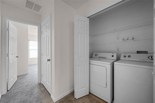 washroom with carpet floors and washing machine and dryer