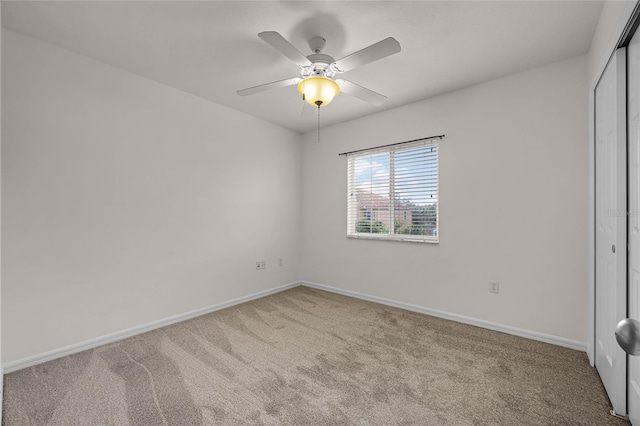 unfurnished bedroom featuring carpet floors, a closet, and ceiling fan