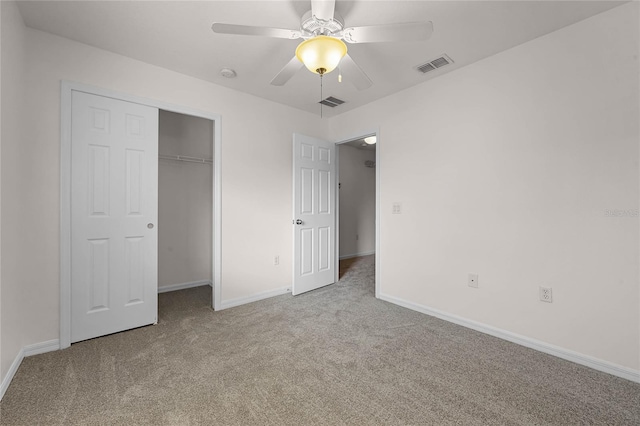 unfurnished bedroom with light carpet, a closet, and ceiling fan