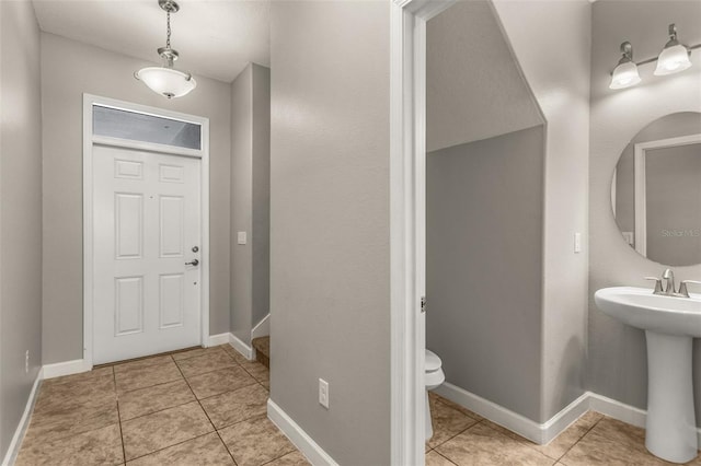 entrance foyer with light tile patterned floors and sink