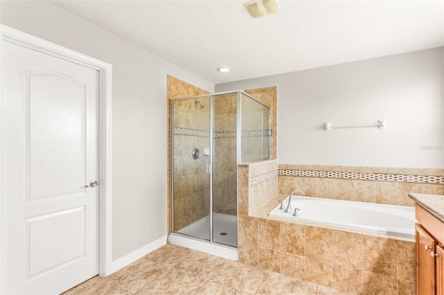 bathroom with tile patterned flooring, vanity, and separate shower and tub