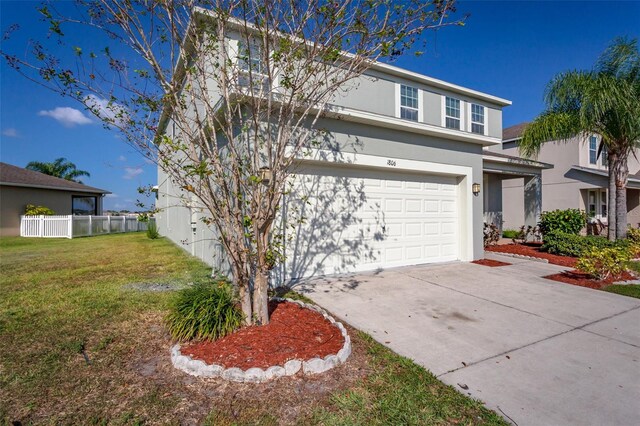 front of property with a front yard and a garage