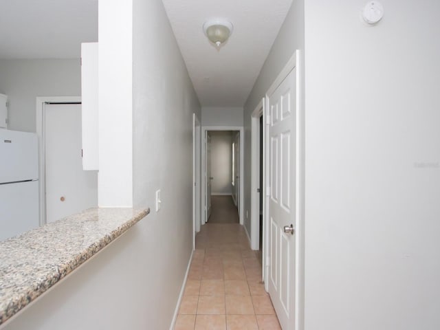 corridor featuring light tile patterned floors