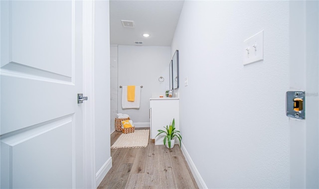 hallway with light hardwood / wood-style flooring