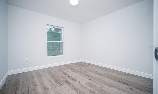 empty room with light hardwood / wood-style flooring