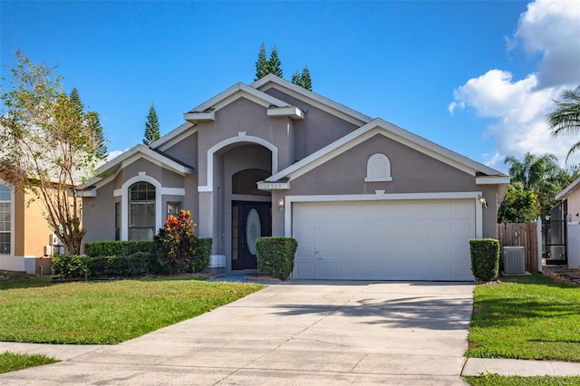 view of property featuring central AC, a front yard, and a garage