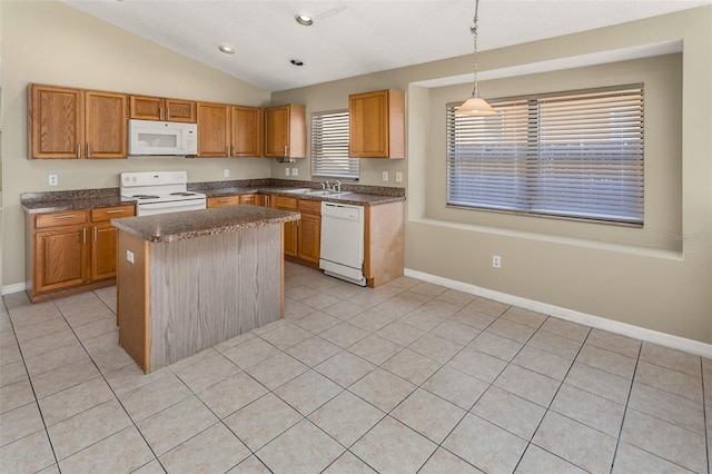 kitchen featuring white appliances, vaulted ceiling, decorative light fixtures, a kitchen island, and light tile patterned flooring