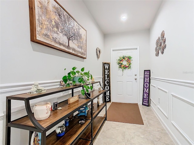 doorway to outside with light tile patterned floors