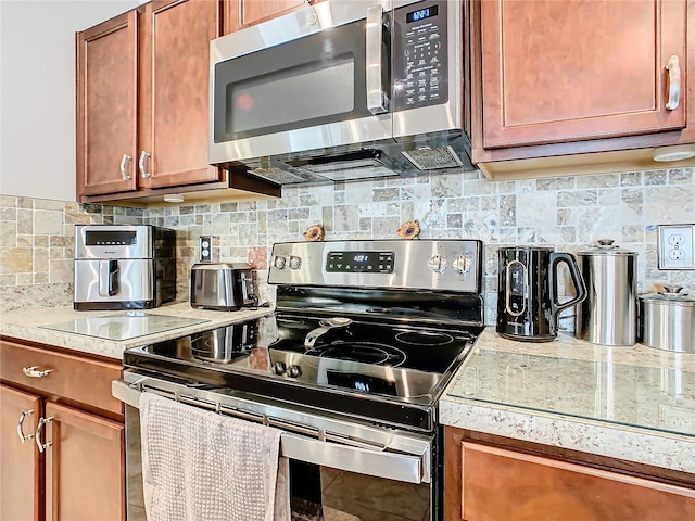 kitchen featuring stainless steel appliances and tasteful backsplash