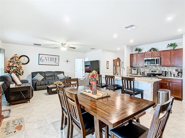 dining area featuring ceiling fan and light tile patterned flooring