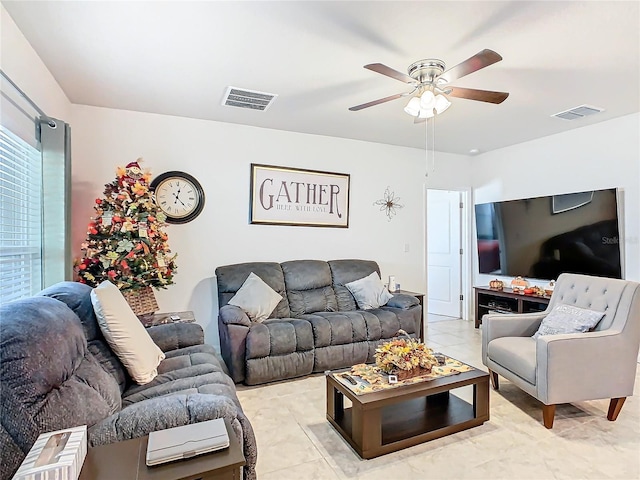 living room with ceiling fan and light tile patterned floors