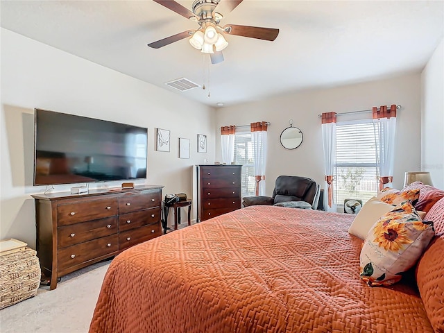 carpeted bedroom featuring multiple windows and ceiling fan