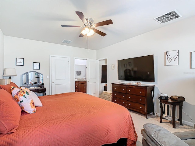 carpeted bedroom featuring ceiling fan and ensuite bathroom