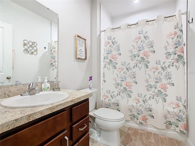 bathroom featuring tile patterned flooring, vanity, and toilet