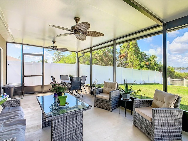 sunroom / solarium featuring ceiling fan