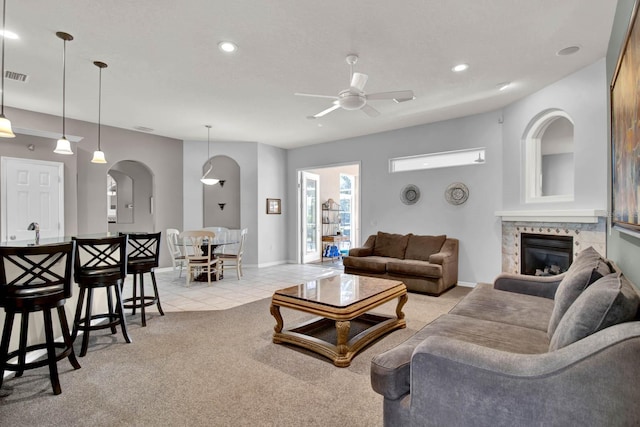 living room featuring light carpet and ceiling fan