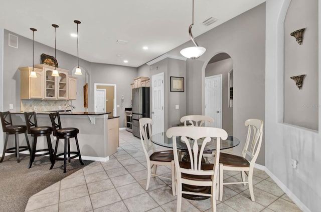 dining area with sink and light tile patterned floors