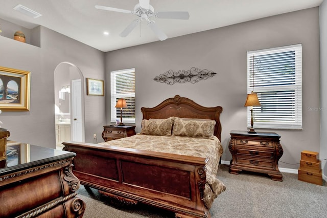 carpeted bedroom featuring ceiling fan and ensuite bathroom