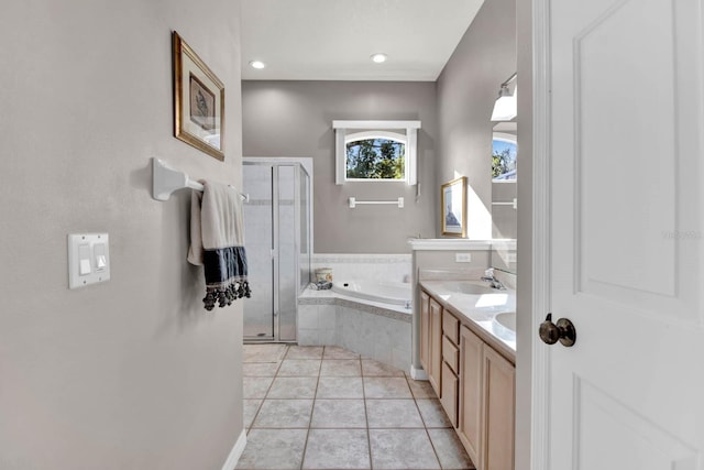 bathroom with tile patterned flooring, vanity, and shower with separate bathtub