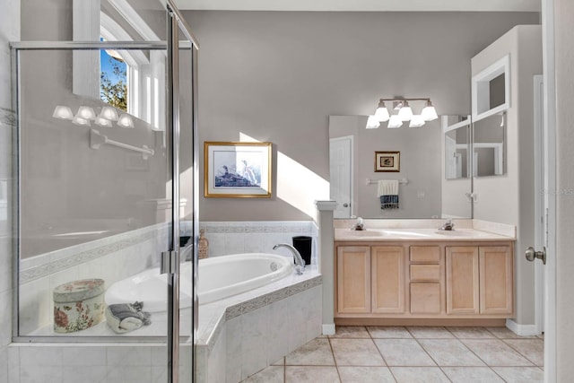 bathroom featuring tile patterned flooring, shower with separate bathtub, and vanity