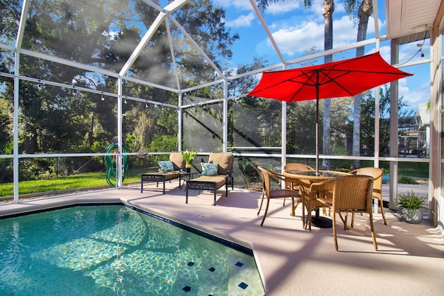 view of swimming pool with a patio area and glass enclosure