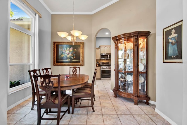 dining area with crown molding, light tile patterned flooring, and a notable chandelier